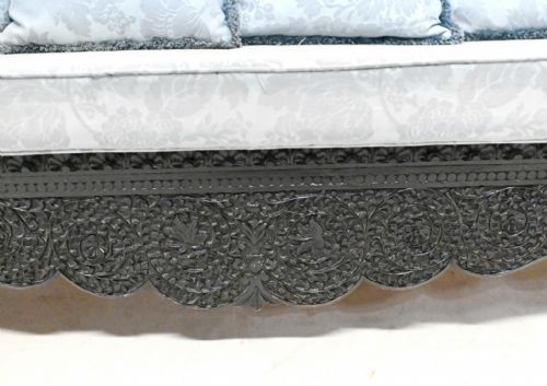 fig 2. An antique Anglo-Indian carved padauk wood suite including a settee and matching armchairs with light blue upholstered cushions.