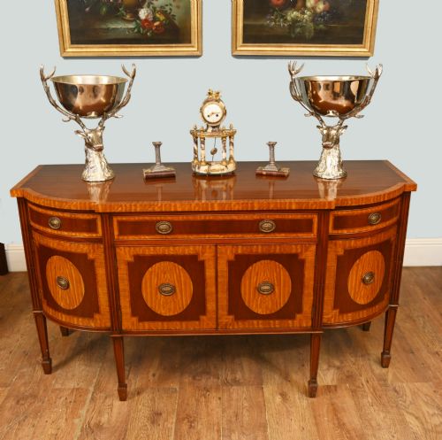 fig 2. An Edwardian Sheraton Revival mahogany sideboard featuring satinwood oval inlay panels, crossbanded edging, brass ring handles, and square tapered legs.