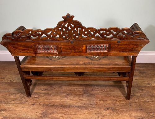 fig 2. A 19th-century Syrian wooden bench featuring geometric marquetry inlay, mother-of-pearl accents, an openwork carved crest, and arched apron support.
