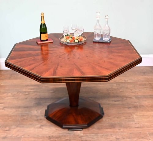 fig 1. An octagonal Art Deco mahogany centre table featuring a sunburst veneer top, banded rim, and a tapered hexagonal pedestal base.