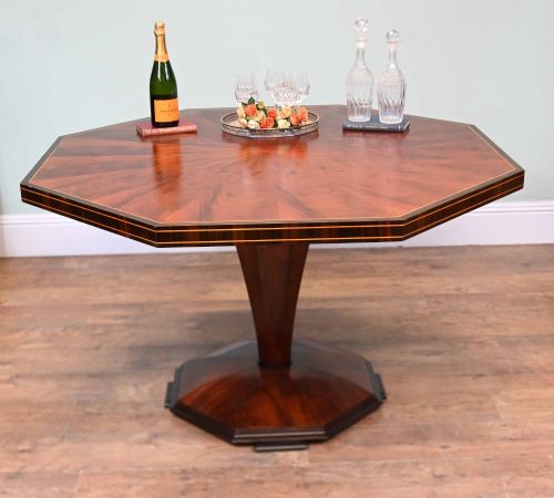 fig 2. An octagonal Art Deco mahogany centre table featuring a sunburst veneer top, banded rim, and a tapered hexagonal pedestal base.