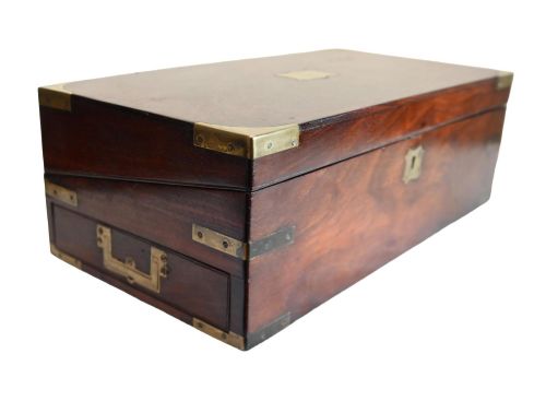 fig 1. A rectangular warm brown mahogany wooden writing slope box featuring brass corner brackets and a shaped brass keyhole escutcheon.