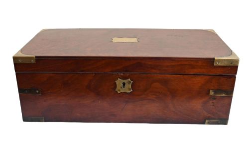 fig 2. A rectangular warm brown mahogany wooden writing slope box featuring brass corner brackets and a shaped brass keyhole escutcheon.