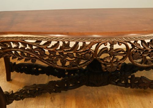 fig 1. A dark hardwood Qing Dynasty console table featuring intricate carved openwork aprons and scrolled cabriole legs.