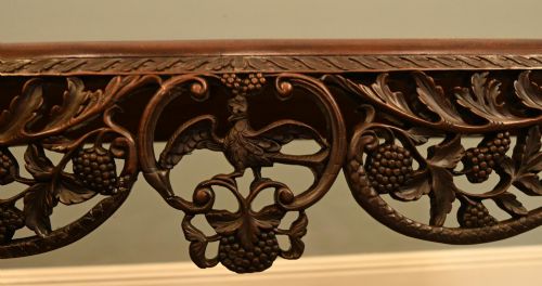 fig 2. A dark hardwood Qing Dynasty console table featuring intricate carved openwork aprons and scrolled cabriole legs.