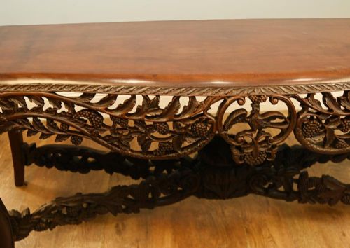 A dark hardwood Qing Dynasty console table featuring intricate carved openwork aprons and scrolled cabriole legs. View XI