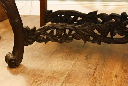 A dark hardwood Qing Dynasty console table featuring intricate carved openwork aprons and scrolled cabriole legs. View XII