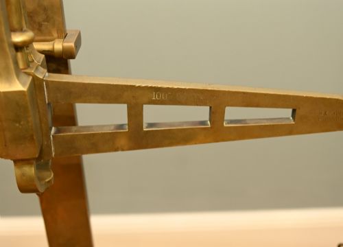 fig 3. A nineteenth-century brass Avery balance scale featuring a tall central pillar, horizontal beam, twin hanging circular pans, and nested counterweights.