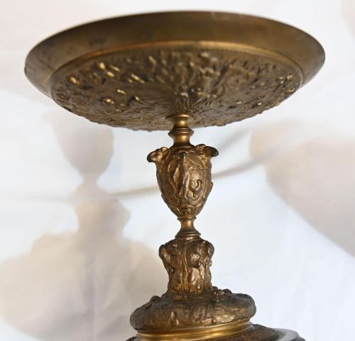 fig 1. A pair of late 19th-century French ormolu classical tazzas with relief-cast circular dishes on decorative stems mounted on round black marble bases.