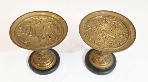 fig 3. A pair of late 19th-century French ormolu classical tazzas with relief-cast circular dishes on decorative stems mounted on round black marble bases.