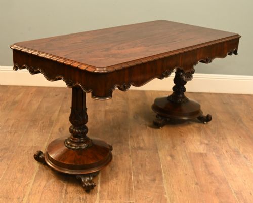 fig 2. A William IV mahogany library table with a carved apron, shell detail, twin pedestal end supports, and scroll feet.