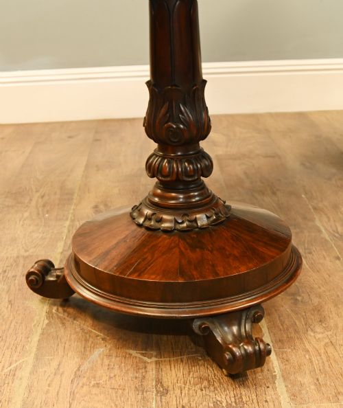 fig 3. A William IV mahogany library table with a carved apron, shell detail, twin pedestal end supports, and scroll feet.