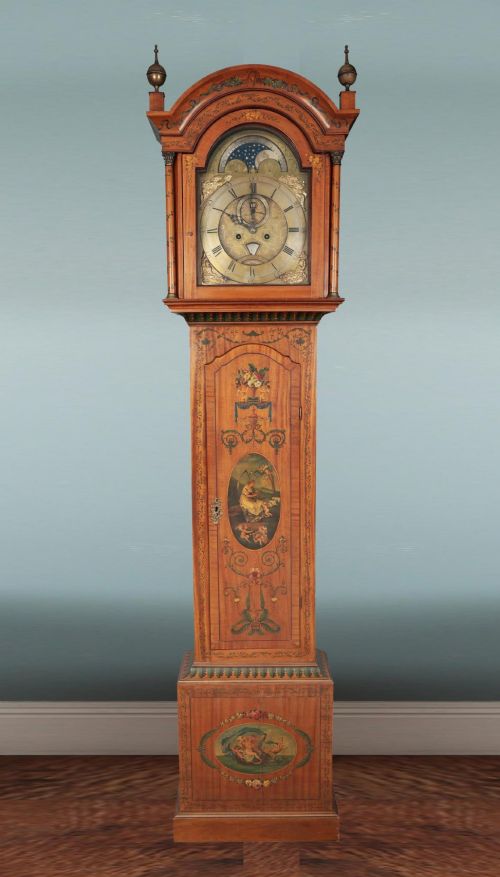 fig 1. An antique Scottish painted satinwood longcase clock with an arched moonphase dial, brass finials, and neoclassical floral painted panels.