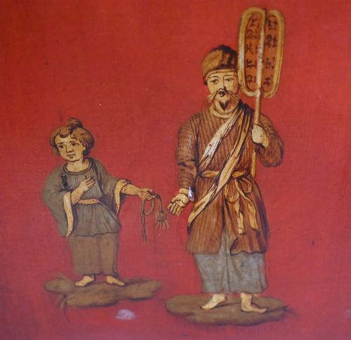 fig 2. A six-panel folding room divider featuring deep red surfaces adorned with gilt rococo scrollwork frames surrounding painted classical figures, cherubs, and urns.