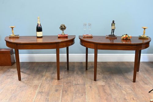 fig 1. A pair of antique Georgian mahogany demi-lune console tables with semi-circular tops and straight tapered legs.