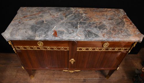 fig 1. A French Empire style rosewood commode with a grey veined marble top, ornamental gilt bronze mounts, and square tapered legs with brass feet.