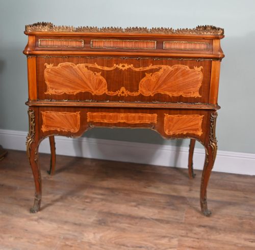 fig 1. An antique French roll-top bureau featuring wood marquetry inlay, decorative brass mounts, cabriole legs, and drawers.