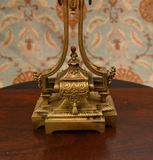fig 2. A 19th-century Louis XVI style gilt bronze clock garniture set comprising a central ornate mantel clock flanked by two matching five-light candelabras.