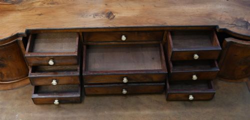 fig 3. A Regency Revival mahogany ladies writing desk featuring a leather-lined writing surface, elevated drawer superstructure, turned reeded legs, and a curved stretcher.