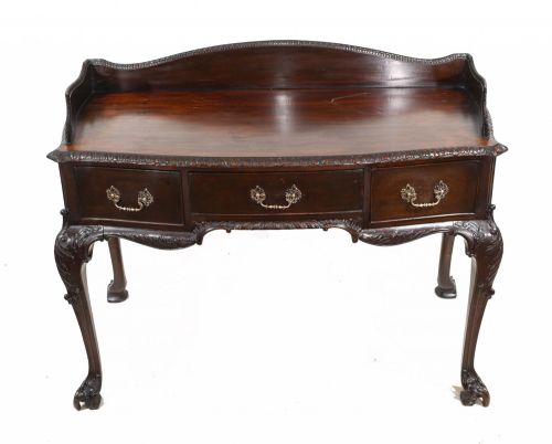 fig 1. A dark mahogany Victorian console table featuring three drawers with decorative brass handles, carved cabriole legs, and a low gallery back.