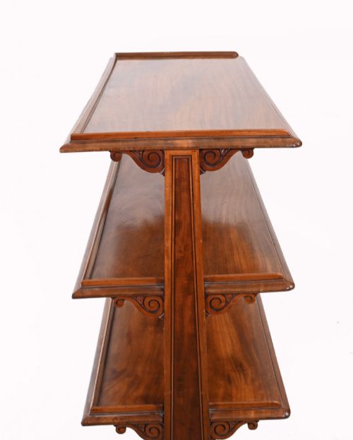fig 1. A Victorian mahogany three-tiered dumb waiter buffet with moulded shelf edges and carved scroll feet.