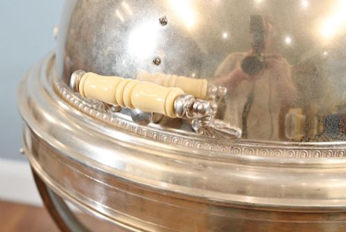 fig 1. A Victorian silver-plated carvery trolley with a domed retractable cover set atop a carved mahogany pedestal base with swivel castors.