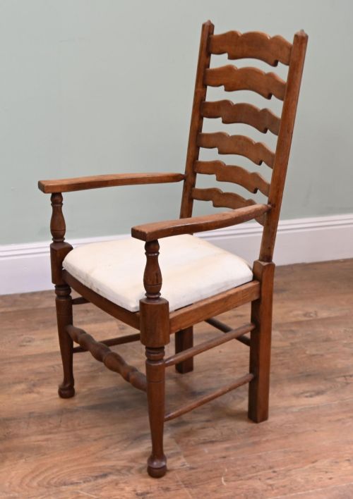 fig 3. A set of four Edwardian oak ladderback dining chairs featuring two armchairs and two side chairs with turned legs and cream fabric seats.