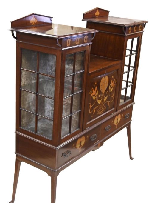 fig 1. An Edwardian Art Nouveau dark mahogany drinks cabinet featuring stylised botanical marquetry inlays, twin glazed side doors, two lower drawers, and slender splayed legs.