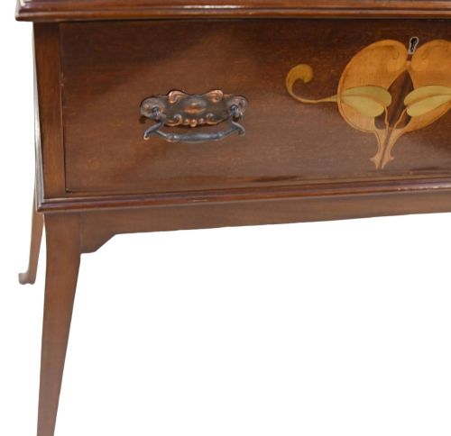 fig 2. An Edwardian Art Nouveau dark mahogany drinks cabinet featuring stylised botanical marquetry inlays, twin glazed side doors, two lower drawers, and slender splayed legs.