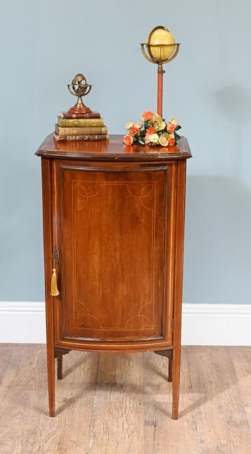 fig 1. A late Victorian bow-fronted mahogany side cabinet with delicate boxwood line inlay, a single door with key, and slender square tapered legs.