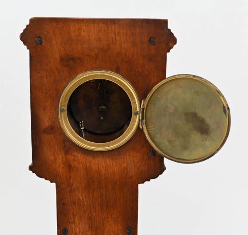 fig 1. A miniature mahogany longcase clock featuring classical Sheraton style wood inlay with an urn motif and a circular white dial with Roman numerals.