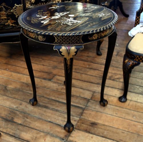 fig 2. A circular black lacquered side table featuring gilded Chinoiserie landscape motifs, bone inlay details, carved cabriole legs, and ball and claw feet.