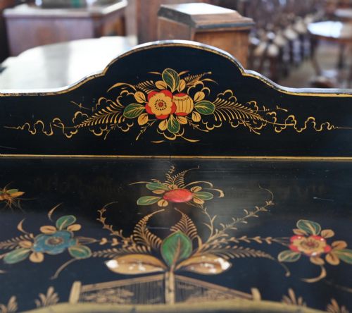fig 1. A black lacquered antique display cabinet featuring hand-painted gilded Chinoiserie scenes, two glazed side doors, and cabriole legs.