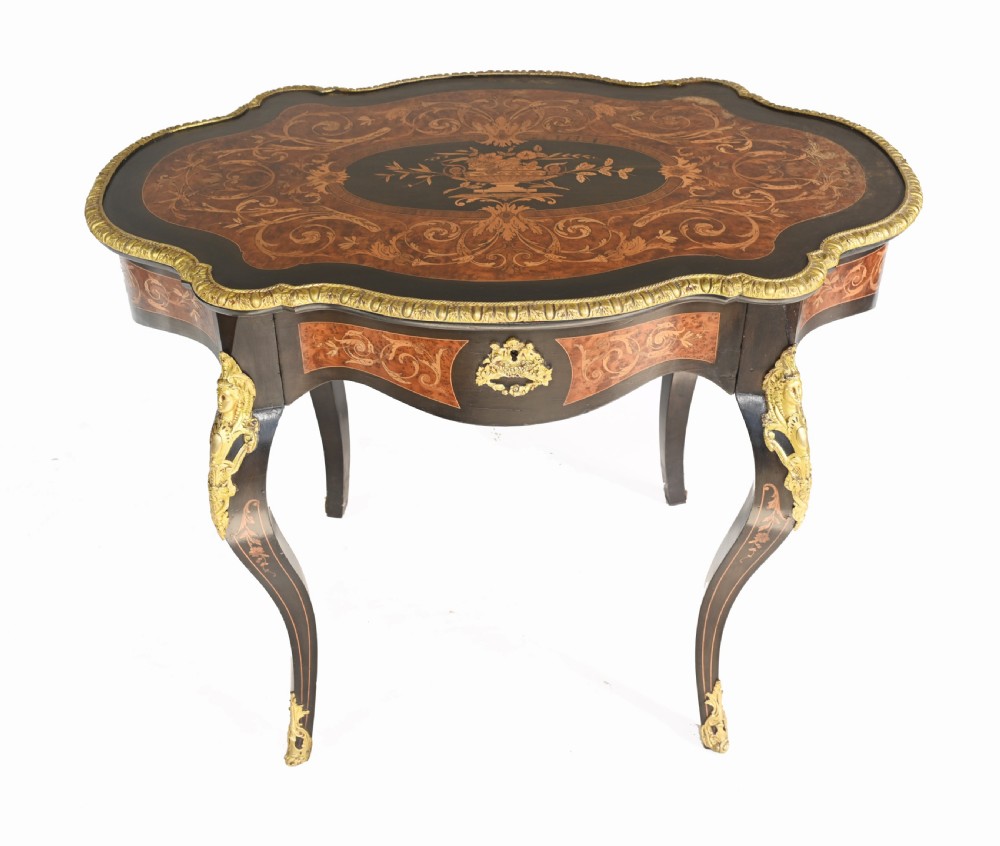 A 19th-century French Louis XV style centre table featuring a serpentine-edged top decorated with floral marquetry inlay, gilt-brass rim mounts, cabriole legs, and a single drawer. View II