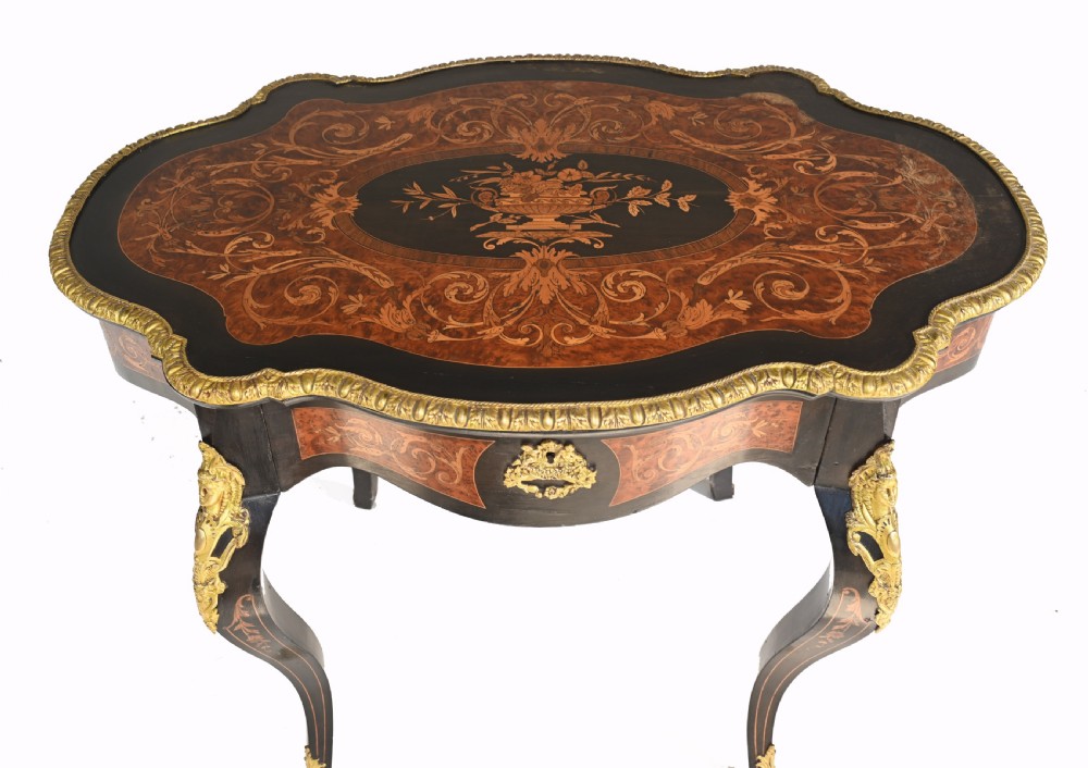 A 19th-century French Louis XV style centre table featuring a serpentine-edged top decorated with floral marquetry inlay, gilt-brass rim mounts, cabriole legs, and a single drawer. View III