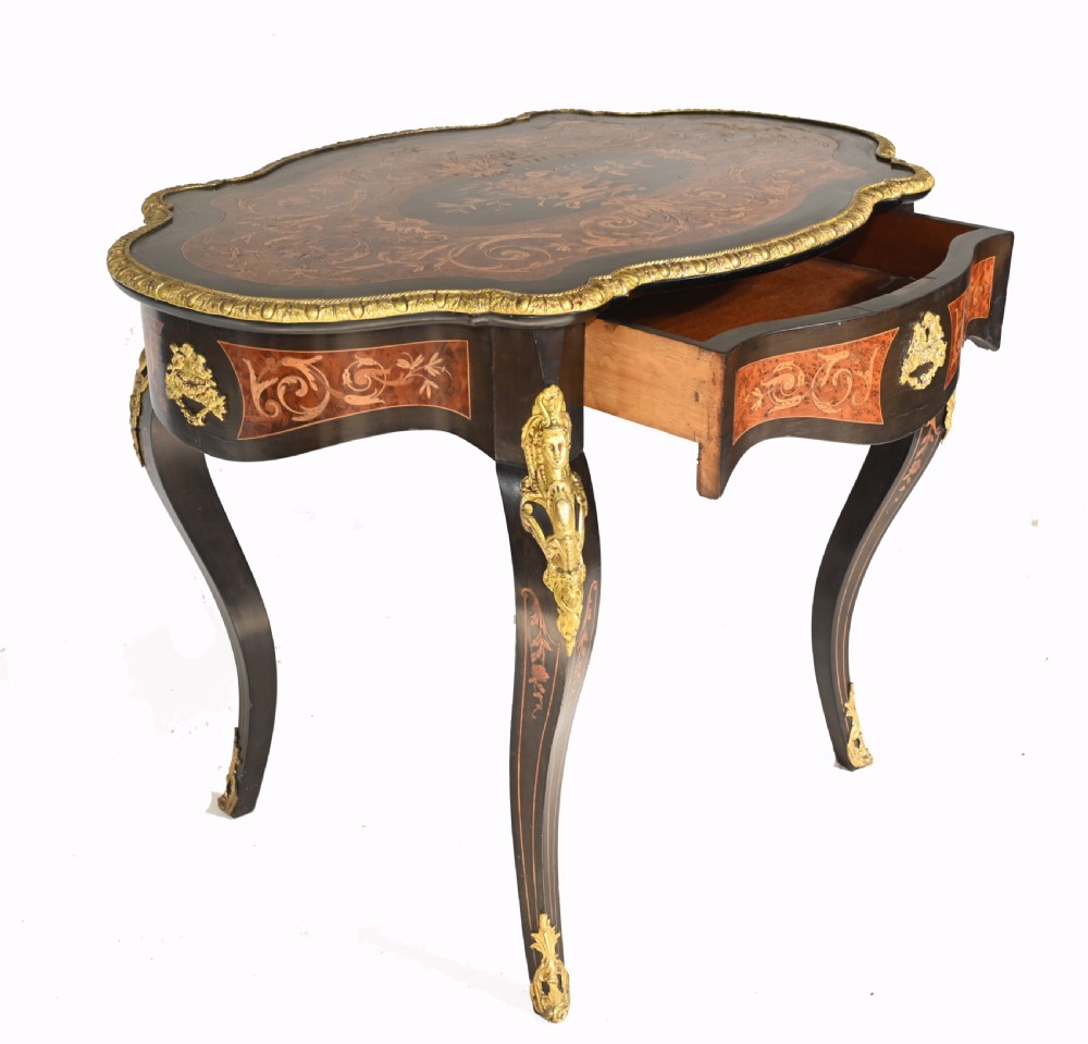 A 19th-century French Louis XV style centre table featuring a serpentine-edged top decorated with floral marquetry inlay, gilt-brass rim mounts, cabriole legs, and a single drawer. View VII