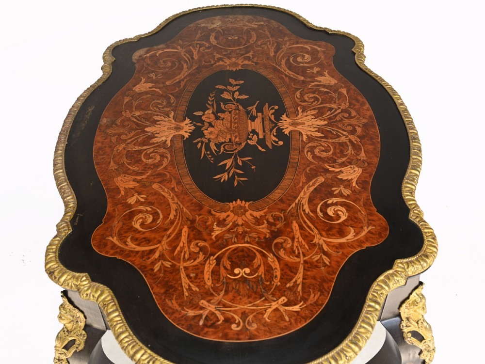 A 19th-century French Louis XV style centre table featuring a serpentine-edged top decorated with floral marquetry inlay, gilt-brass rim mounts, cabriole legs, and a single drawer. View IX
