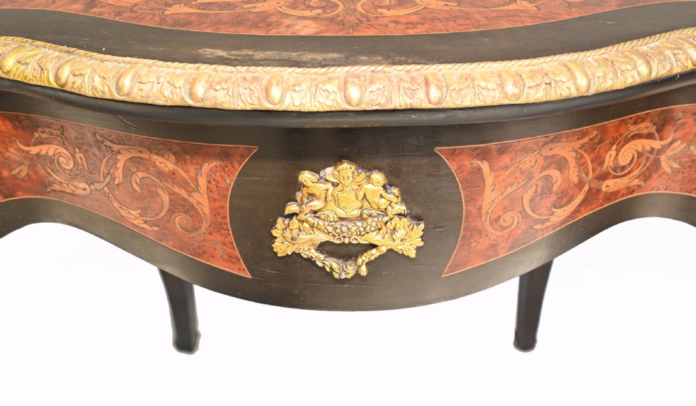 A 19th-century French Louis XV style centre table featuring a serpentine-edged top decorated with floral marquetry inlay, gilt-brass rim mounts, cabriole legs, and a single drawer. View XII