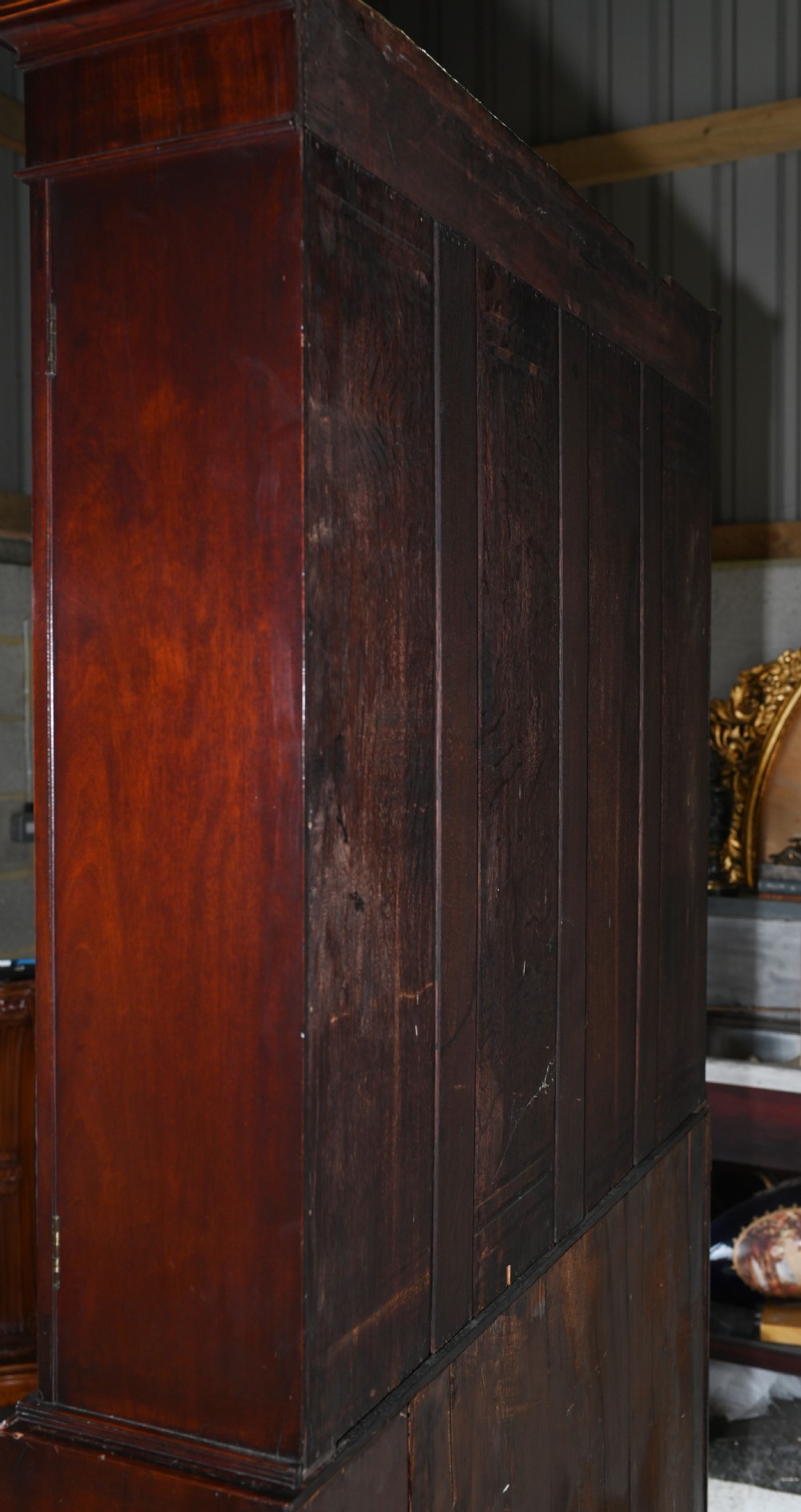 A late 18th-century mahogany bureau bookcase featuring upper astragal glazed double doors with an oval shell marquetry pediment, above a slanted fall-front writing desk and four graduating drawers with brass handles. View XIII
