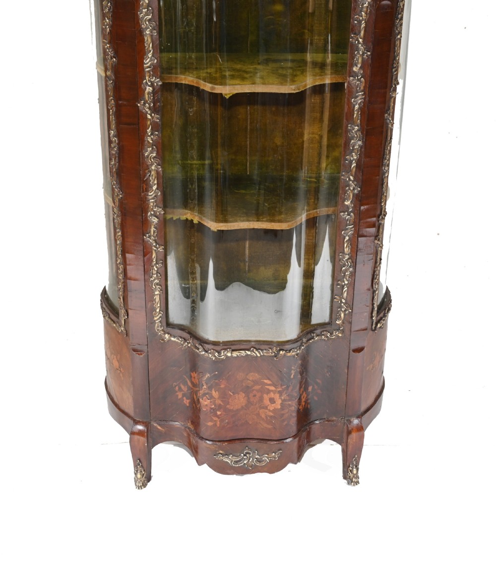 An antique French glazed vitrine cabinet with curved glass panels, floral marquetry inlay on the lower doors, and ornate brass ormolu mounts. View II