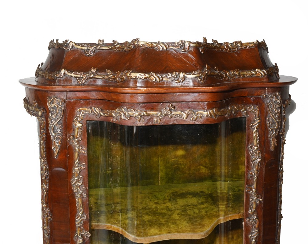 An antique French glazed vitrine cabinet with curved glass panels, floral marquetry inlay on the lower doors, and ornate brass ormolu mounts. View III
