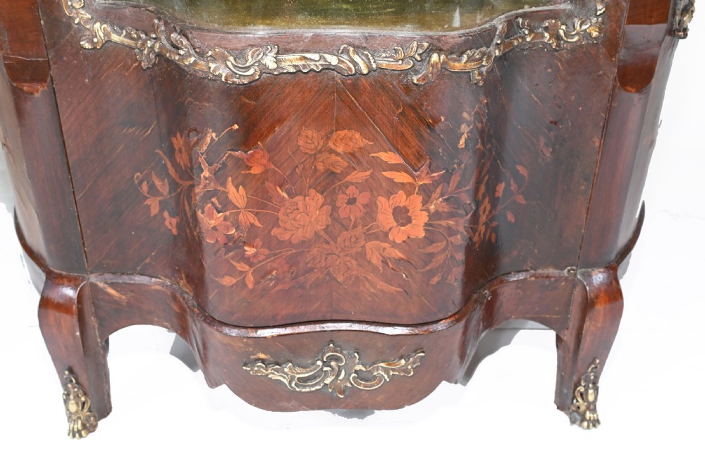 An antique French glazed vitrine cabinet with curved glass panels, floral marquetry inlay on the lower doors, and ornate brass ormolu mounts. View VI