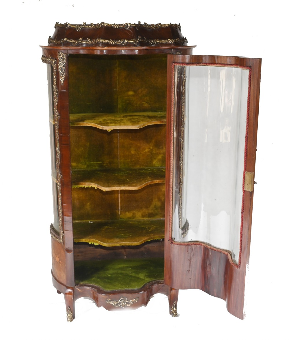 An antique French glazed vitrine cabinet with curved glass panels, floral marquetry inlay on the lower doors, and ornate brass ormolu mounts. View VIII