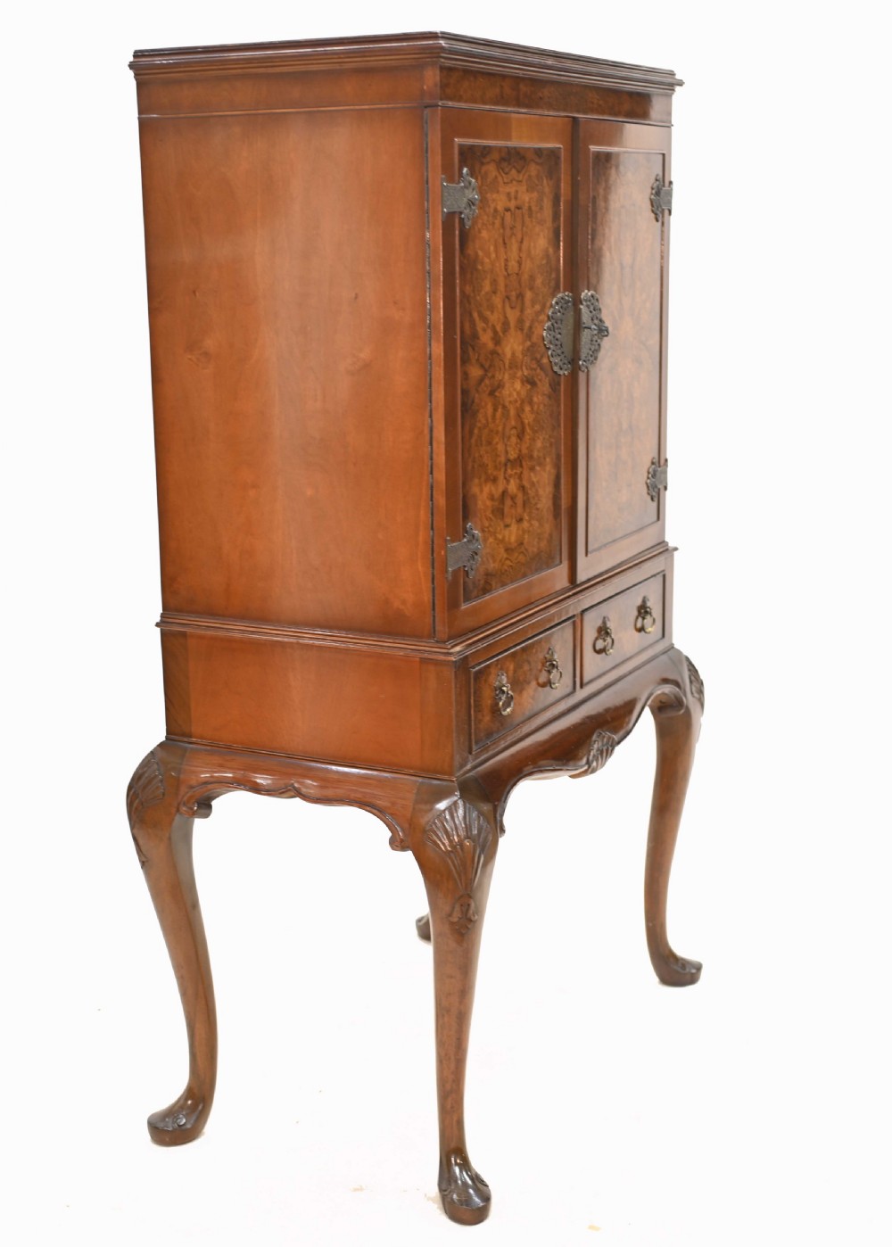 An Art Deco burr walnut drinks cabinet on a carved cabriole leg stand with ornate brass hardware and two lower drawers. View VIII