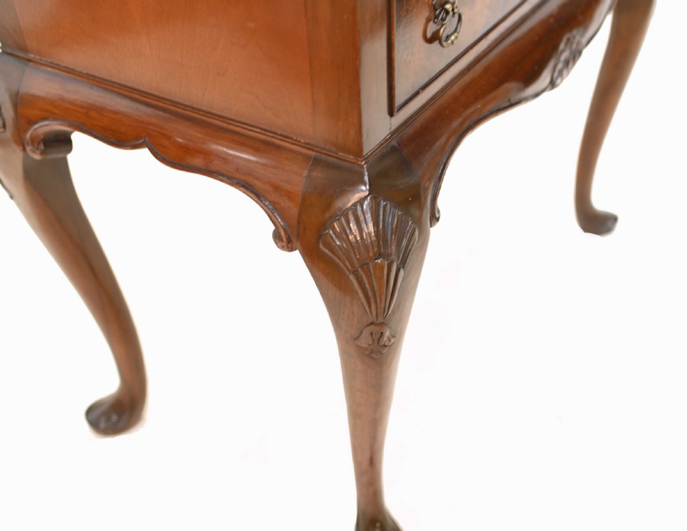 An Art Deco burr walnut drinks cabinet on a carved cabriole leg stand with ornate brass hardware and two lower drawers. View IX