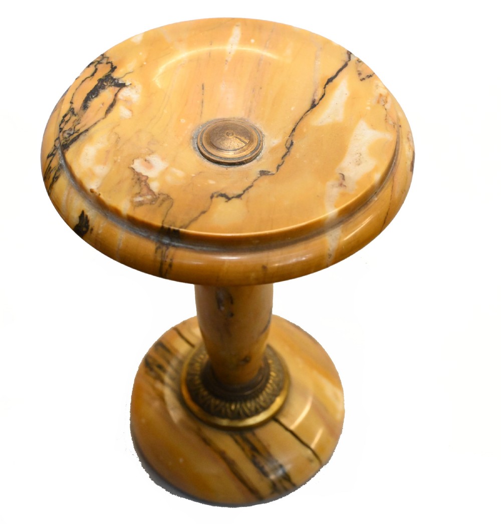 An antique French three-piece garniture set featuring an arched yellow veined marble clock flanked by two matching marble pedestal tazzas. View V