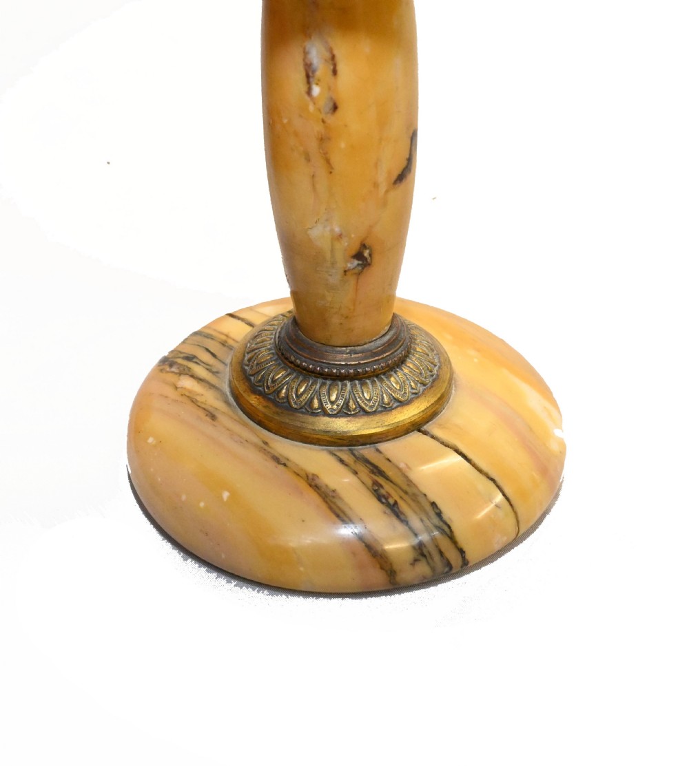 An antique French three-piece garniture set featuring an arched yellow veined marble clock flanked by two matching marble pedestal tazzas. View VI