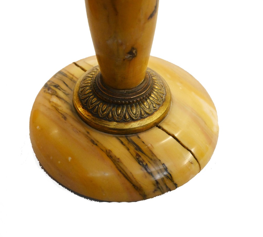 An antique French three-piece garniture set featuring an arched yellow veined marble clock flanked by two matching marble pedestal tazzas. View VII