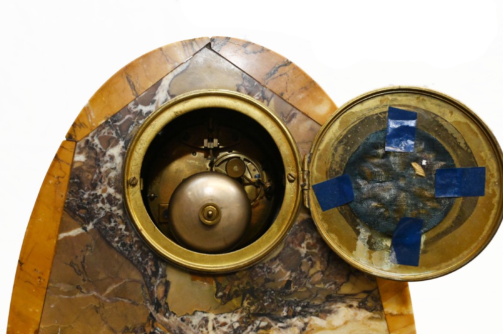 An antique French three-piece garniture set featuring an arched yellow veined marble clock flanked by two matching marble pedestal tazzas. View XIII