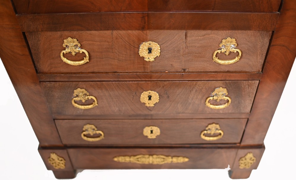 A late 19th-century French Empire mahogany escritoire desk featuring a dark marble top, drop-front writing compartment, three lower drawers, and ornamental gilt-bronze mounts. View III